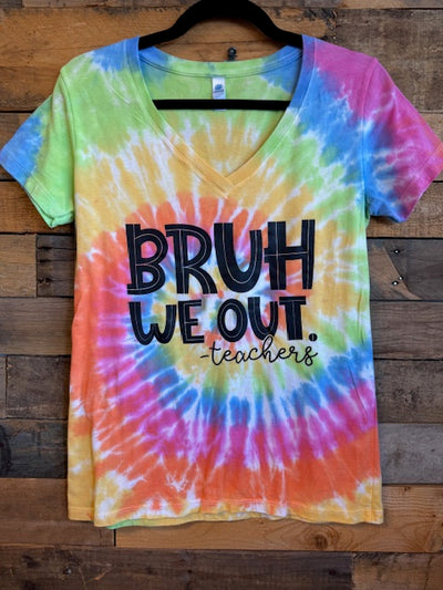 Colorful tie-dye shirt with text on a wooden surface