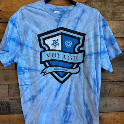 Blue tie-dye t-shirt with a logo on a wooden surface