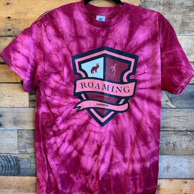 Pink tie-dye shirt with a graphic design on a wooden surface