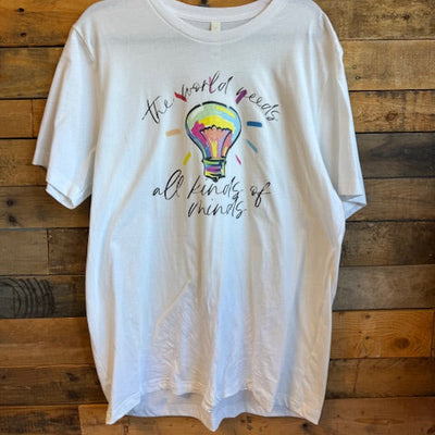 White tshirt with colorful design and text on a wooden surface