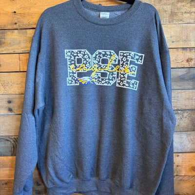 Gray crewneck sweatshirt with a logo on a wooden surface