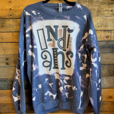 Folded blue and white patterned shirt with a brand logo on a wooden surface