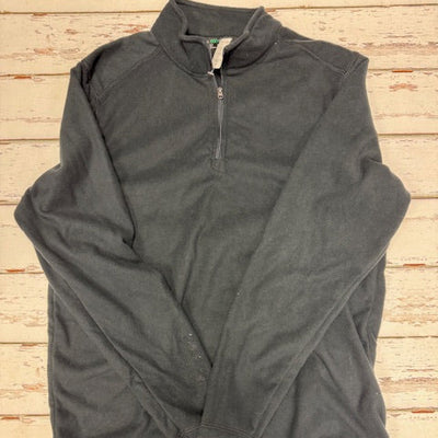 black fleece 1/4 zip on a wooden surface