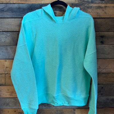 Turquoise shirt on a wooden surface