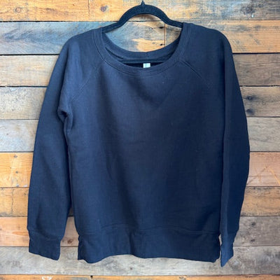 black sweatshirt on a wooden surface