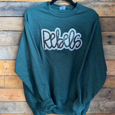 Green sweatshirt with 'Rebels' text on a wooden background