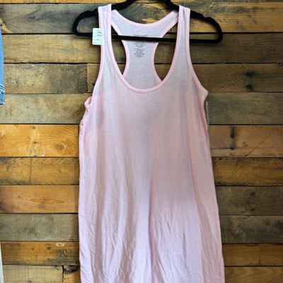 Pink tank top on a hanger against a wooden background