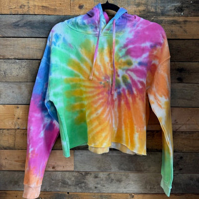 Colorful tie-dye hoodie on a wooden surface