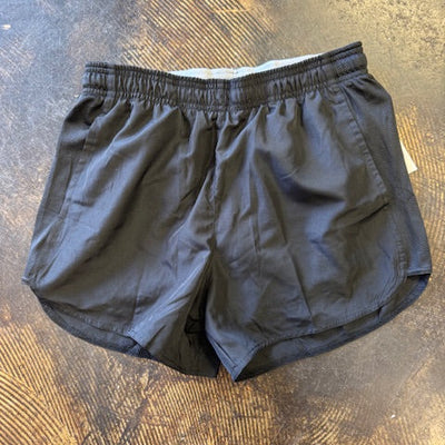 Black shorts on a textured brown surface