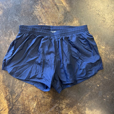 navy blue running shorts on a textured brown surface