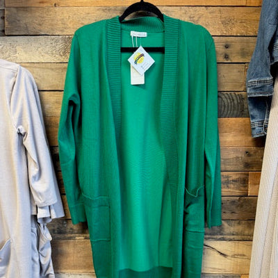 Green cardigan on a wooden surface 