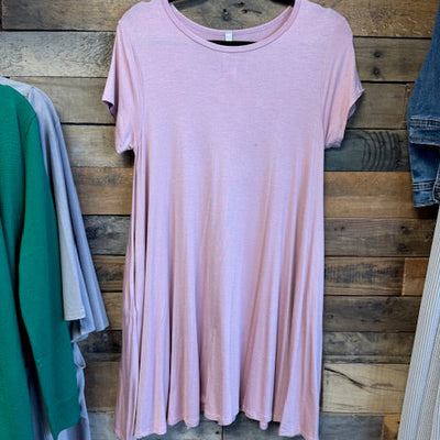 Pink dress on a wooden surface