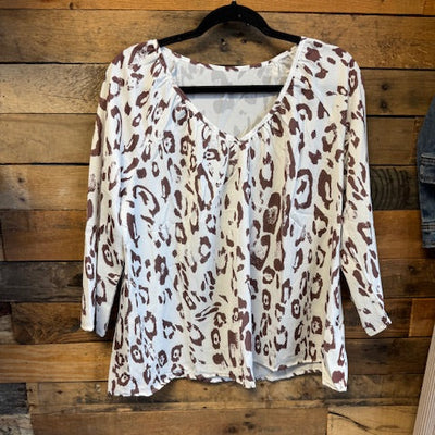 Leopard print shirt on a wooden surface