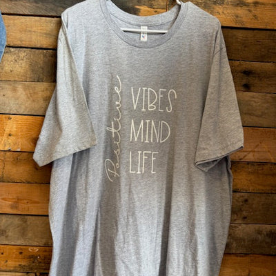Gray shirt with text on a wooden surface