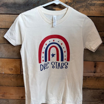 cream t-shirt with red, blue, and white design on a wooden surface