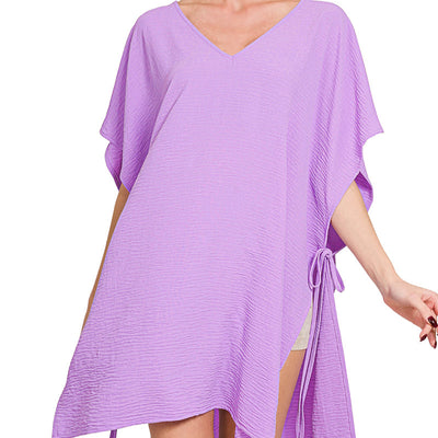 Woman wearing a purple cover-up dress on a white background