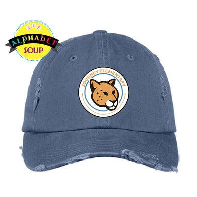 Journey Elementary logo on a distressed blue hat