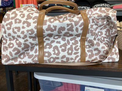 Leopard print duffel bag with brown straps