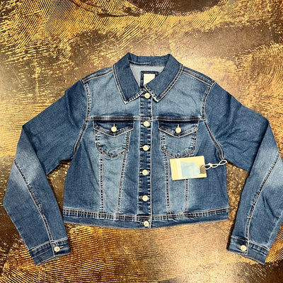 Blue denim jacket on a textured gold surface