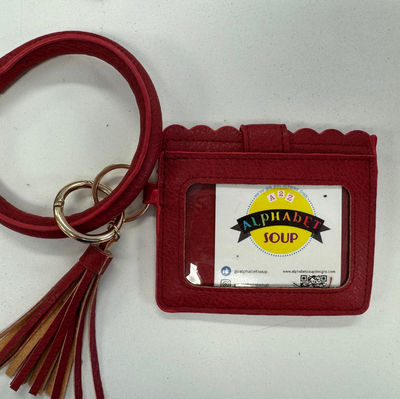 Red keychain with card holder featuring a visible brand logo on a white background