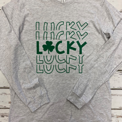 grey long sleeved tee with repeating "lucky" word